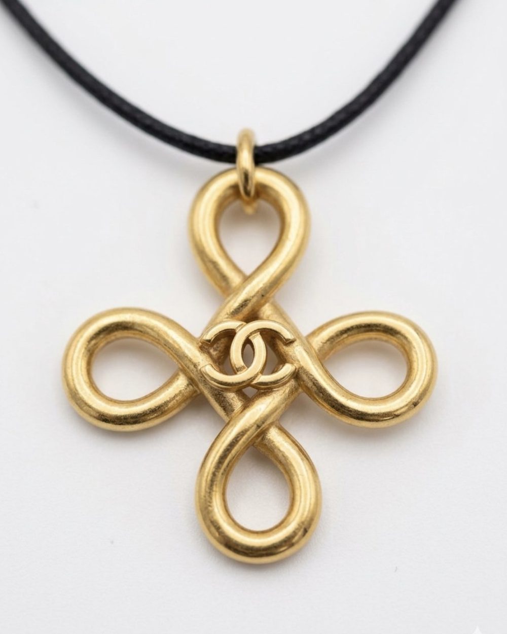 Clover Knot on cord, charm close-up — Maison Dorée vintage charm necklace