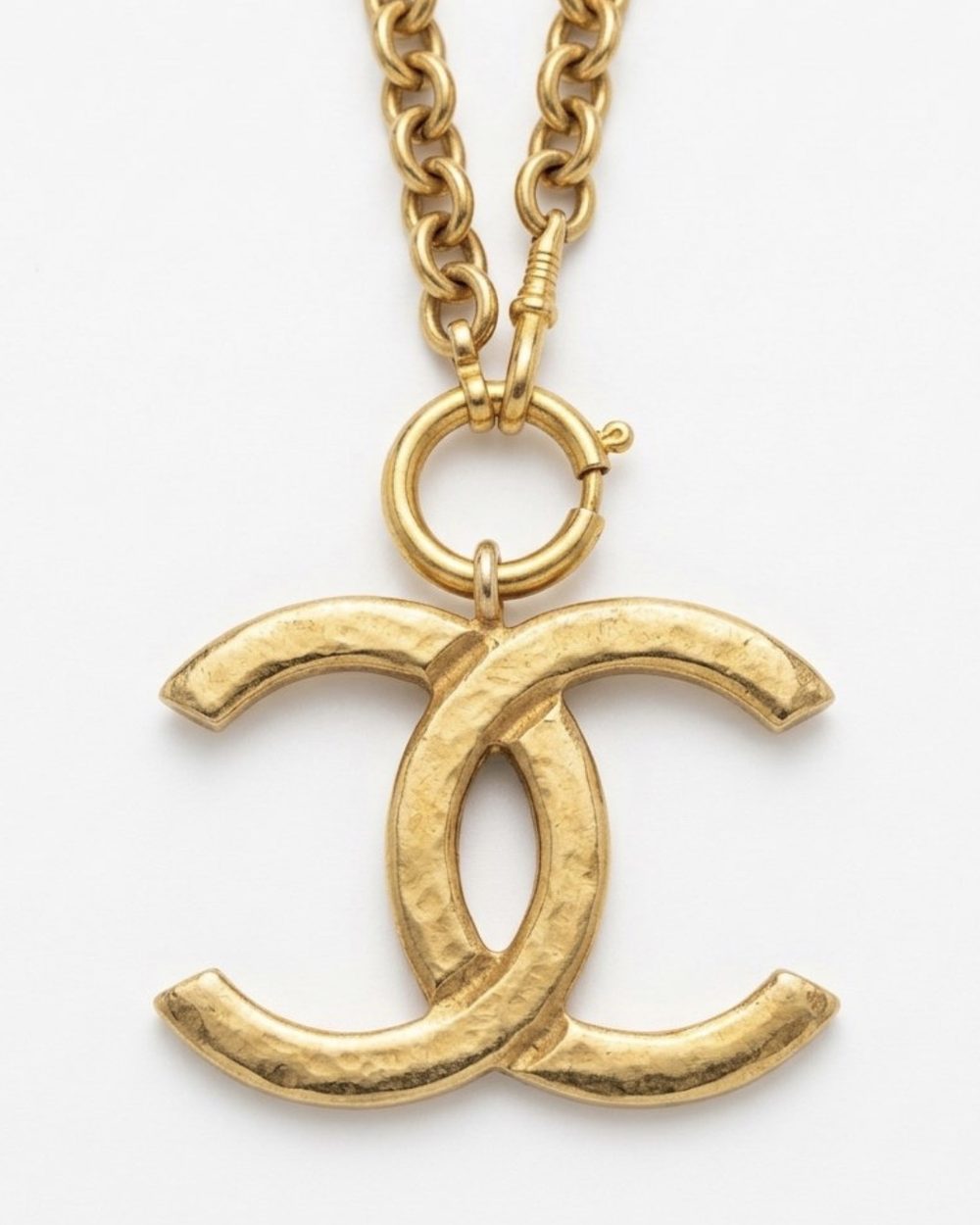 Interlock Pendant on chain, charm close-up — Maison Dorée vintage charm necklace