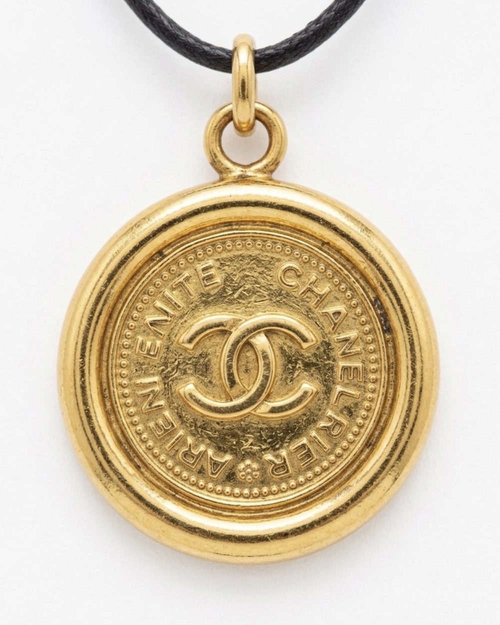 Paris Coin on cord, charm close-up — Maison Dorée vintage charm necklace