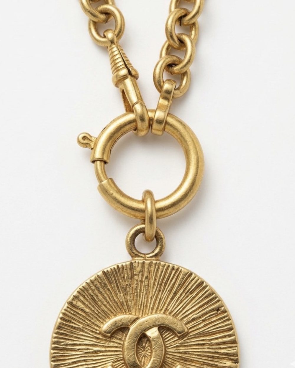 Sunburst on chain, charm close-up — Maison Dorée vintage charm necklace