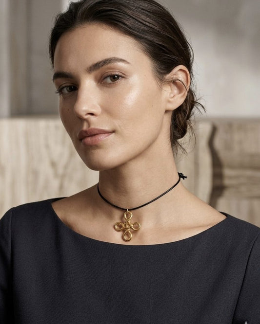 Clover Knot on cord, worn on a model — Maison Dorée vintage charm necklace