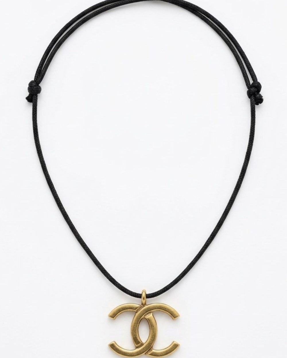 Interlock Pendant on cord, product photo — Maison Dorée vintage charm necklace
